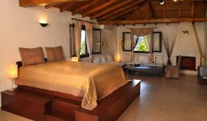 a bedroom with a bed and a living room at Heos Accommodation in Ormos Panagias