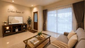 a living room with a couch and a tv at Urban Homie 40 in Langu