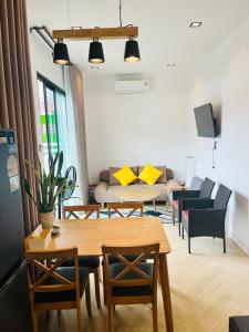 a living room with a table and a couch at Beas Boutique House Khlong Dow in Ko Lanta