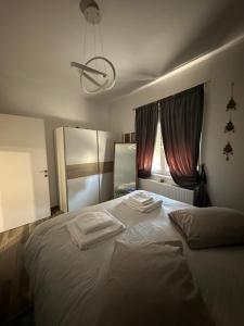 a bedroom with a bed with towels on it at Mimis House in Tsotílion