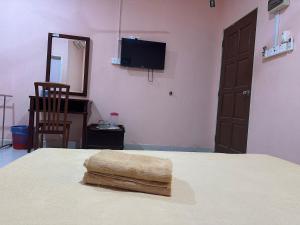 a bedroom with a bed with a towel on it at Huda Inn in Pantai Cenang +54 photos