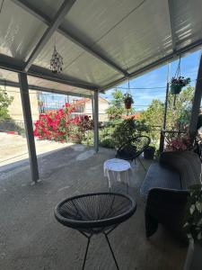 a patio with a table and chairs under a tent at Mimis House in Tsotílion