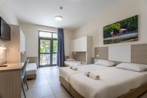 a hotel room with two beds and two flamingos at HI - Karei Deshe Hostel in Khirbet Minim +28 photos