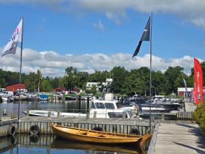 a boat is docked at a dock with flags at Malenasro in Karlshamn