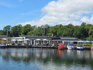 a building with a dock next to a body of water at Malenasro in Karlshamn