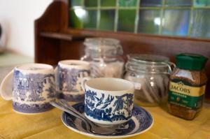 a table with blue and white cups and jars and spoons at The Olive Room in Kampersrus AH