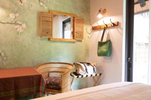 a bedroom with a bed and a window and a chair at The Olive Room in Kampersrus AH