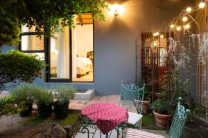 a patio with chairs and a table in front of a house at The Olive Room in Kampersrus AH