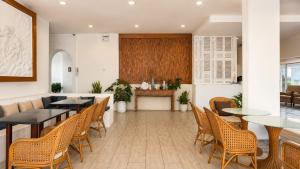 a restaurant with tables and chairs and a counter at Royal Beach View in Pattaya South