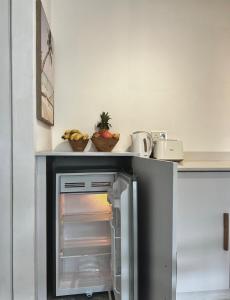 a kitchen with an open refrigerator with a counter at Little Palm Studio in Cap Malheureux