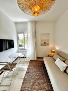 a living room with a couch and a table at Little Palm Studio in Cap Malheureux