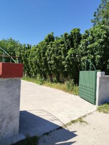 a green gate on the side of a road at Ogi in Straševina