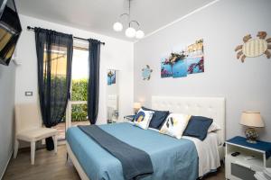 a bedroom with a blue bed and a window at Brisa Home Beach in Mazzeo