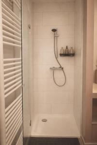 a bathroom with a shower with a glass door at Hoeve Verdre - De Knechtenwoning in Heers
