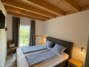 a bedroom with a bed with two blue pillows at Am Hof Jungholz in Jungholz +70 photos