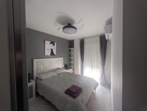 a bedroom with a white bed and a window at San Juan nº10 in Jaén
