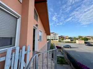 a balcony of a building with a fence and a car at Grace Home in Assemini
