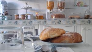 a plate of croissants and bread on a counter at Phiniscollis B&B in La Caletta