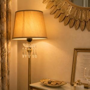 a lamp sitting on a table next to a wall at GOLDENSPACE by Evagelias Homes Volos in Volos