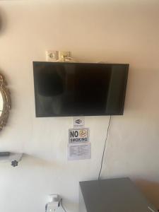 a flat screen tv hanging on a wall at Two Palm Trees 1 in Adamantas