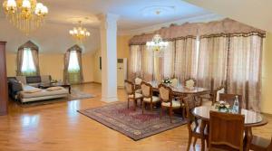 a living room with a table and chairs and a couch at Retro Palace Residence Tashkent in Toshkent-Passajir Bekati