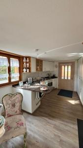 a kitchen with a counter and a chair in a room at Rosenhüsli in Gerzensee