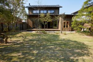 a house with a large yard in front of it at 岩室久元 in Niigata