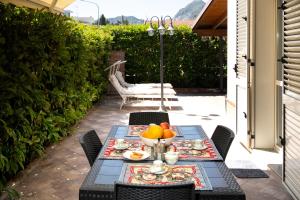 a table with a bowl of fruit on a patio at Brisa Home Beach in Mazzeo