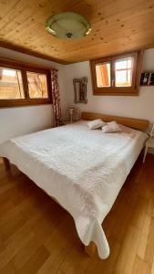 a bedroom with a large white bed in a house at Rosenhüsli in Gerzensee
