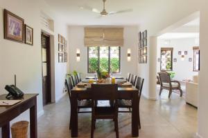 a dining room with a table and chairs at Rodrigo House in Colombo