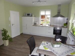 a kitchen with a table and a dining room at Philippsburg in Monreal