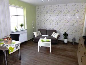 a living room with a couch and a table at Philippsburg in Monreal