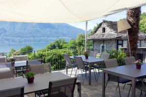 a patio with tables and chairs with a view at Rustico senza punti in Contra