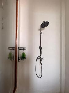 a shower in a wall with a shower head at Queen house in Waikabubak