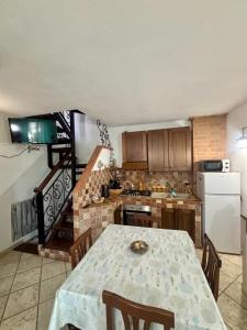 a kitchen with a table and a kitchen with a staircase at casetta sul porticciolo in Stintino +32 photos