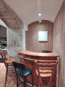 a bar in a room with chairs and a television at gite La Tour Au Comté in Charency +22 photos