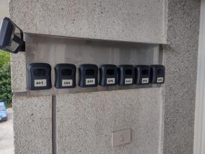a row of clocks on the side of a building at Isa Rooms Sarria in Sarria