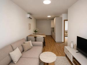 a living room with a couch and a television at Valeri Lux Becici in Rafailovici