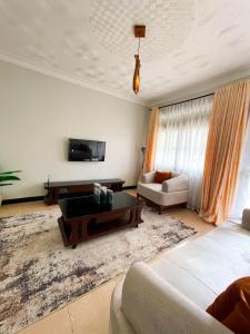 a living room with a couch and a table at Happy homes stay in Namugongo +5 photos