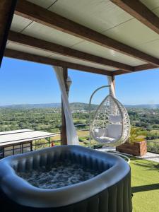 a hot tub on the deck of a house with a view at SunnyHill Villa in Shkodër