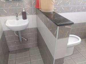 a bathroom with a sink and a toilet at Prithivee Homestay in Kotagiri