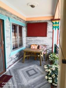 a room with a table and two windows at Buddhi Boutique in Pokhara