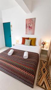 a bedroom with a large bed in a room at Holiday House Kata & Karon Phuket Hotel in Kata Beach