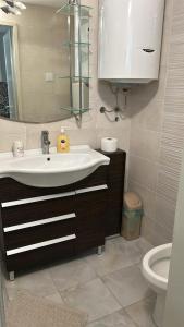 a bathroom with a sink and a toilet at Casa Verde in Boreti +31 photos