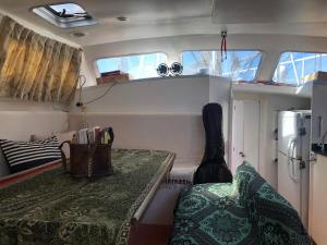a small boat with a table in the back of it at Passeio diurno e hospedagem de Veleiro Maverick in Paraty +8 photos