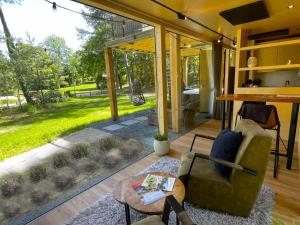 a living room with a couch and a table at Skydeck Cabin met Jacuzzi & Rooftop in Holten