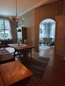 a living room with a table and a dining room at Skärvsta gamla skola in Sollefteå
