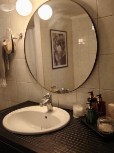 a bathroom with a sink and a mirror at Skärvsta gamla skola in Sollefteå +11 photos