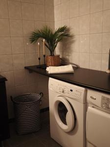 a washing machine in a kitchen with candles on a counter at Skärvsta gamla skola in Sollefteå