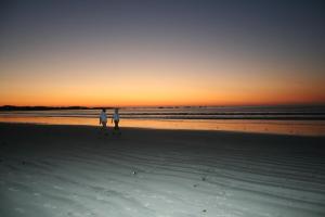 two people walking on the beach at sunset at Baywatch Paternoster - The Cottage in Paternoster